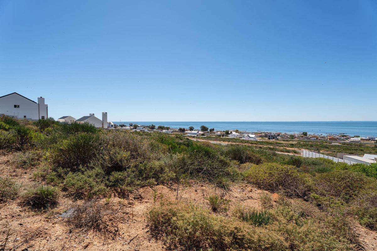 A scenic elevated view overlooking the coastal landscape, surrounding residential properties, and the ocean horizon.