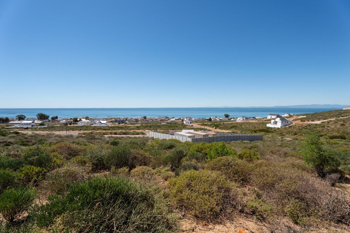 A scenic elevated view overlooking the coastal landscape and ocean, showcasing the surrounding residential area and natural terrain.