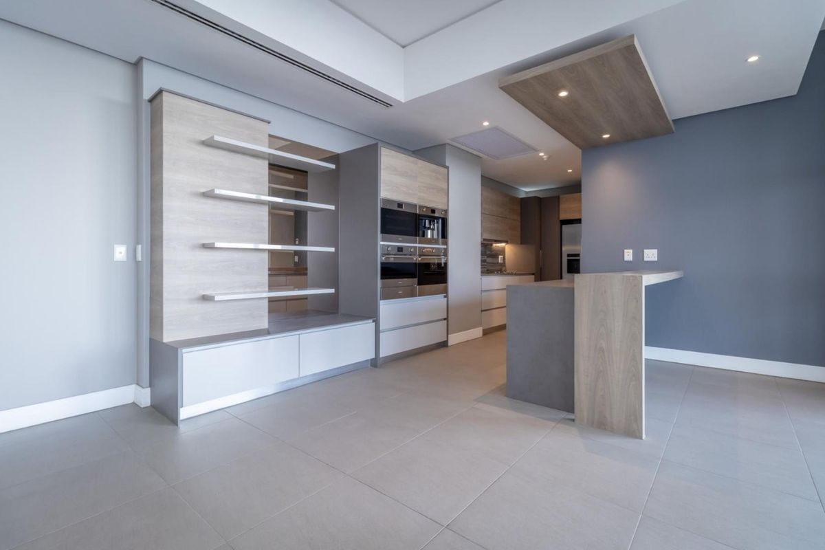 Modern kitchen featuring high-end built-in appliances, sleek cabinetry, a functional island, and recessed lighting in a contemporary open-plan layout.