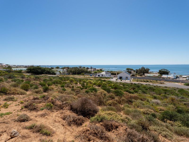 A scenic elevated view overlooking the coastal landscape, surrounding neighborhood, and the ocean horizon.