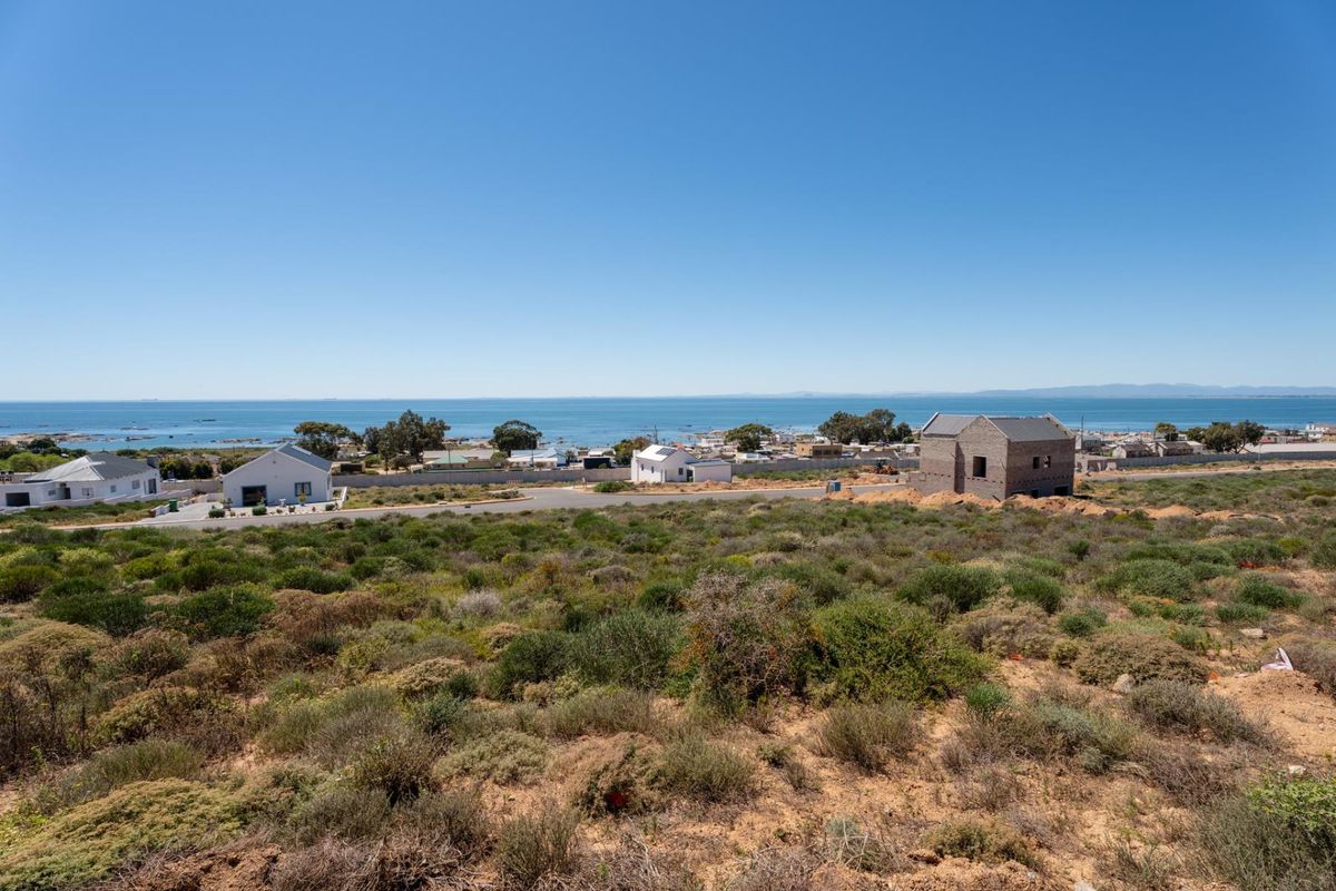 A scenic elevated view overlooking the coastal landscape, surrounding residential properties, and the ocean horizon.