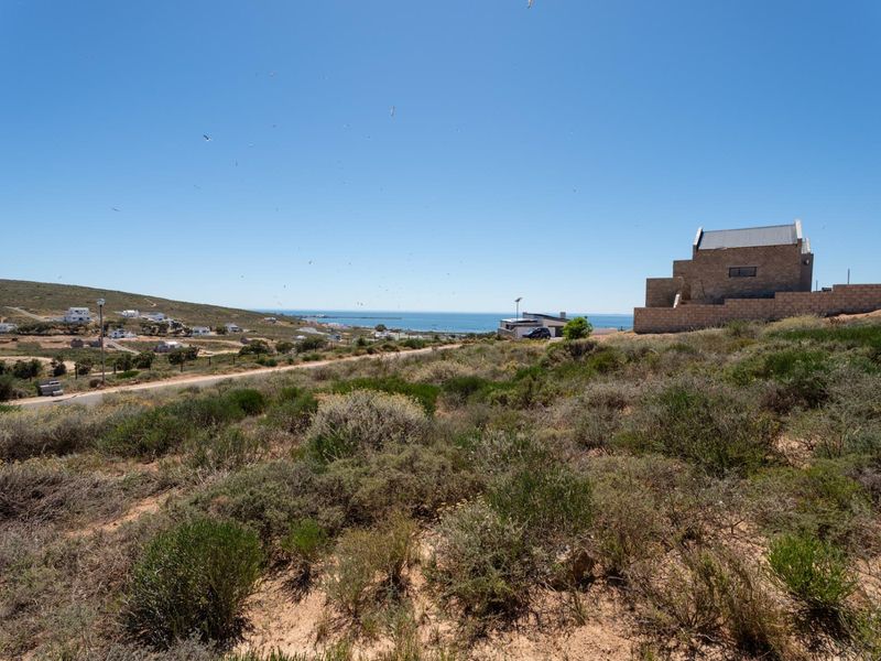 A scenic view of the coastal landscape and surrounding residential area from the vacant residential land.
