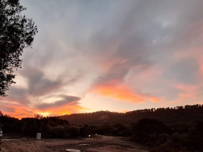 A scenic view of the natural landscape and hillside at sunset, showcasing the tranquil environment of the vacant residential land.