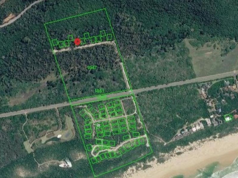 Aerial view of the residential land parcel showing site boundaries, surrounding vegetation, and proximity to the coastline and local road network.