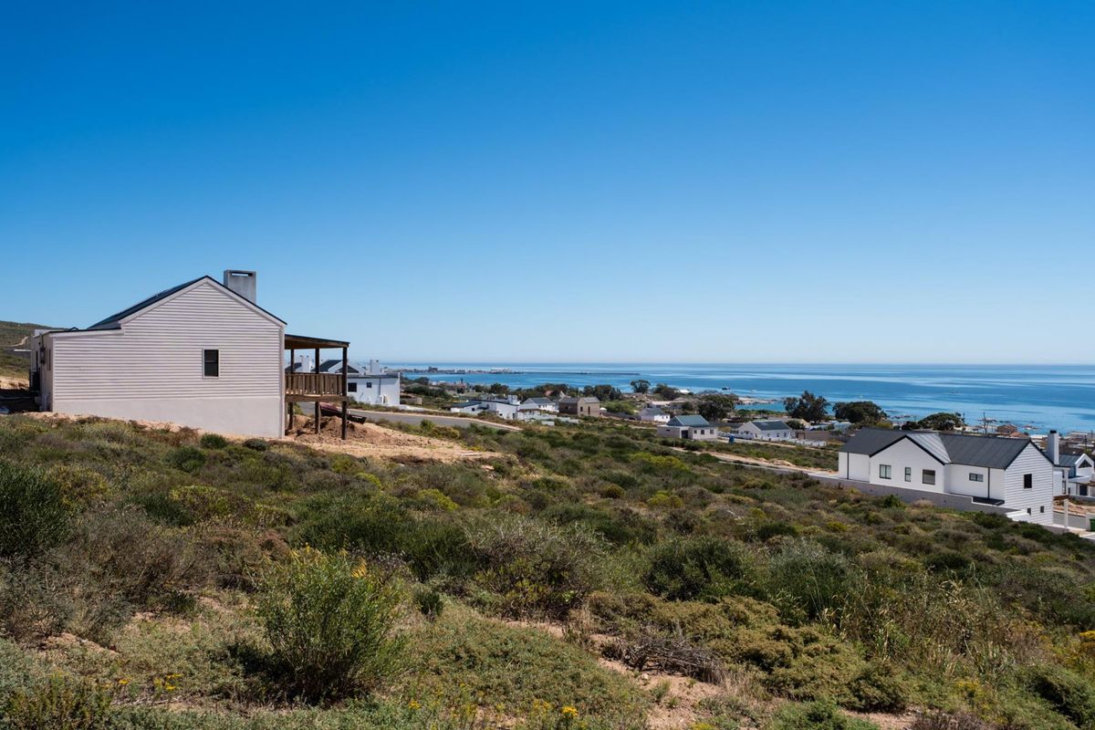A scenic elevated view overlooking the coastal landscape, surrounding residential properties, and the ocean horizon.