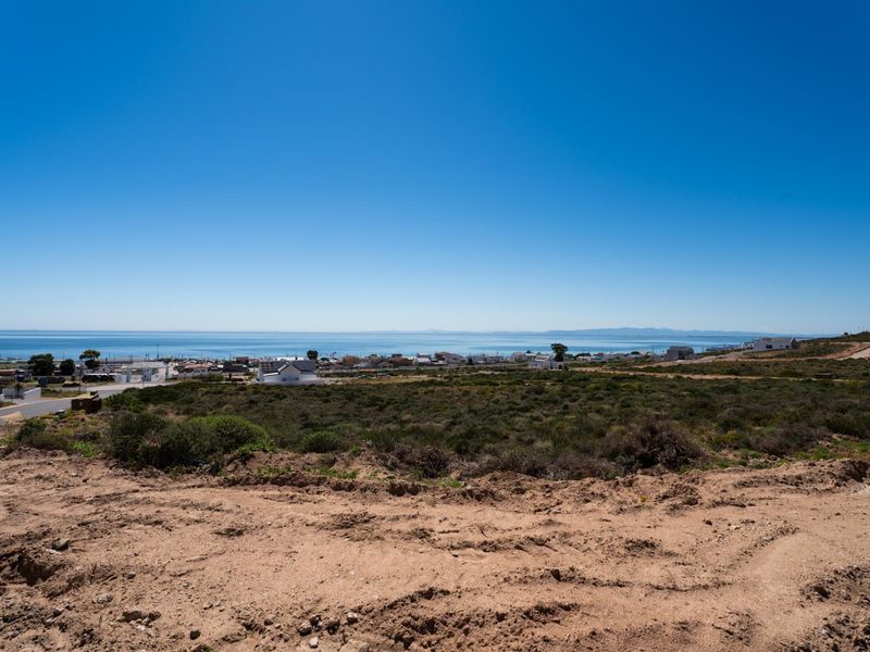 A wide-angle view of the coastal landscape and ocean from the vacant residential plot.