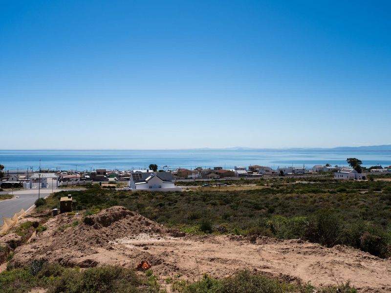 A scenic elevated view overlooking the coastal landscape, surrounding residential neighborhood, and the ocean horizon.