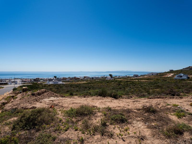 Elevated view overlooking the coastal landscape and ocean from the vacant residential land.