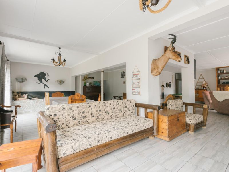 Spacious open-plan living area featuring neutral tiled flooring and a bright, airy layout suitable for versatile furniture arrangements.