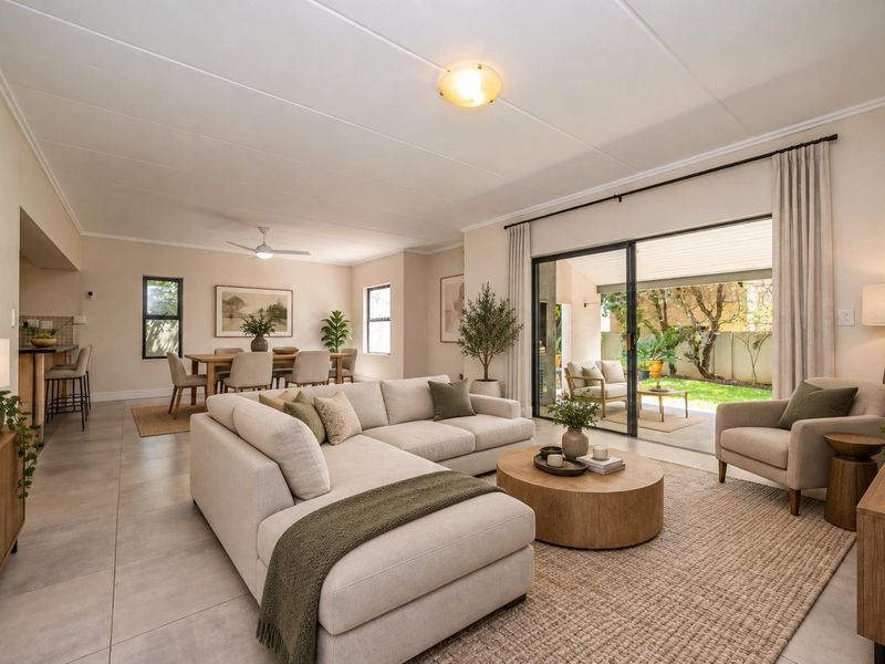 Spacious open-plan living and dining area featuring tiled floors, a ceiling fan, and large sliding glass doors providing seamless access to the rear patio.