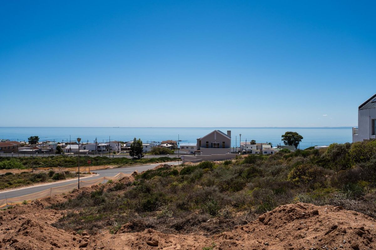 A scenic elevated view overlooking the coastal landscape, surrounding residential neighborhood, and the ocean horizon.