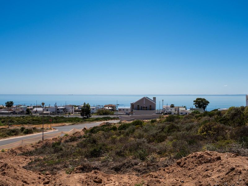 A scenic elevated view overlooking the coastal landscape, surrounding residential neighborhood, and the ocean horizon.