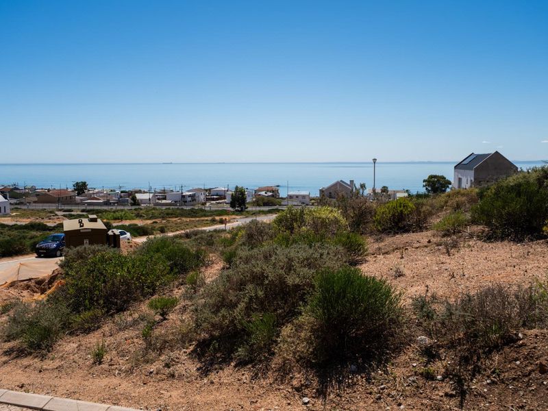 A scenic view overlooking the coastal landscape and ocean from the vacant residential land.