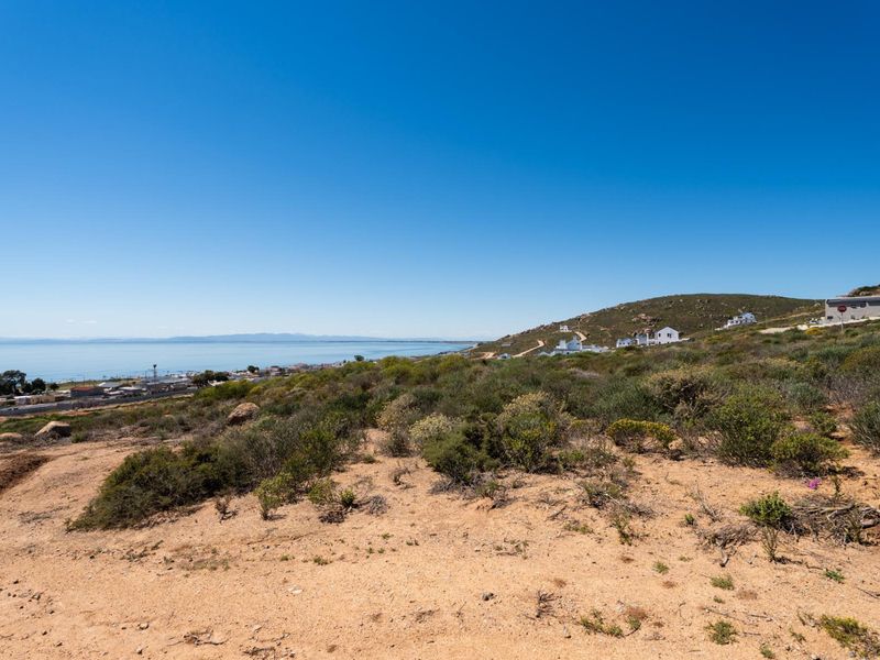 A scenic view overlooking the coastal landscape and surrounding hillside, showcasing the natural terrain and proximity to the ocean.