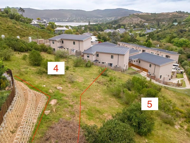 Aerial view of vacant residential land plots with established retaining walls and surrounding residential development.