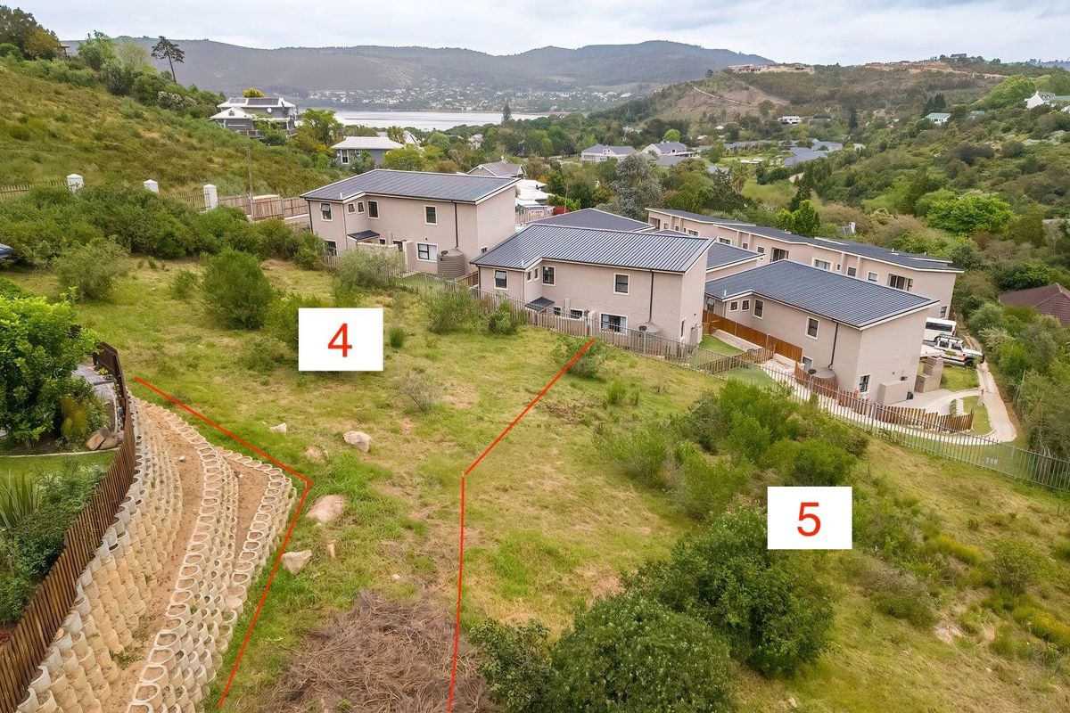 Aerial view of vacant residential land plots with established retaining walls and surrounding residential development.