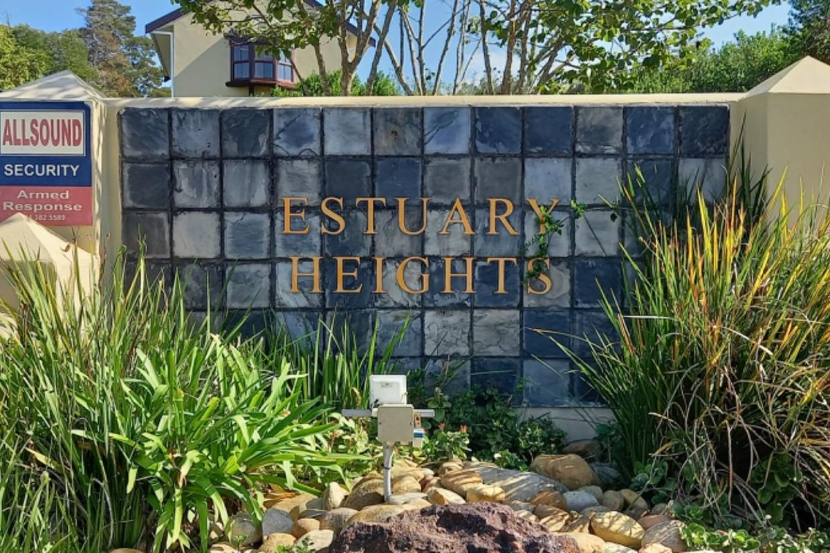 Entrance signage and boundary wall for Estuary Heights residential estate, featuring stone cladding and security gate access.