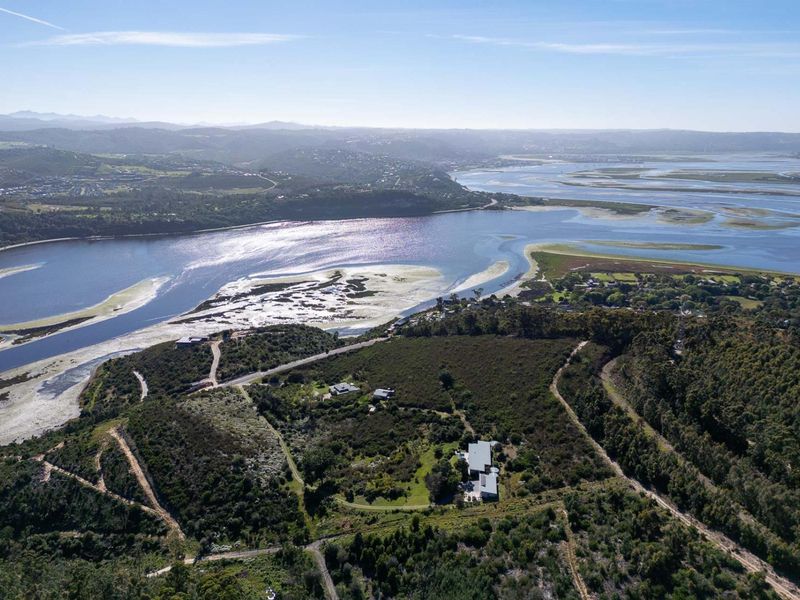 An expansive aerial view of the farm property, showcasing its elevated position overlooking the scenic estuary and surrounding natural landscape.