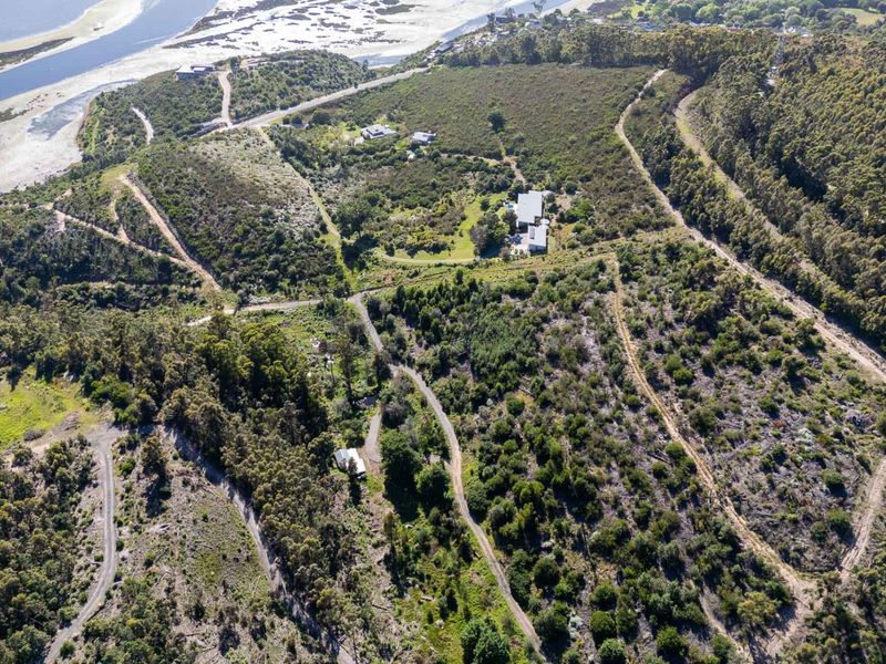 An aerial view of the expansive farm property, showcasing the natural landscape, private access roads, and proximity to the coastline.