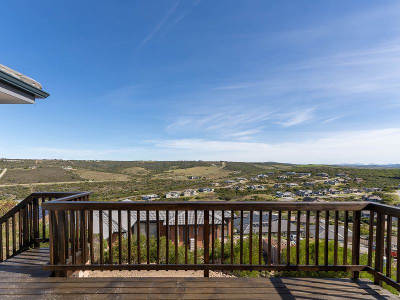 Elevated timber balcony offering expansive panoramic views over the surrounding landscape and residential estate.