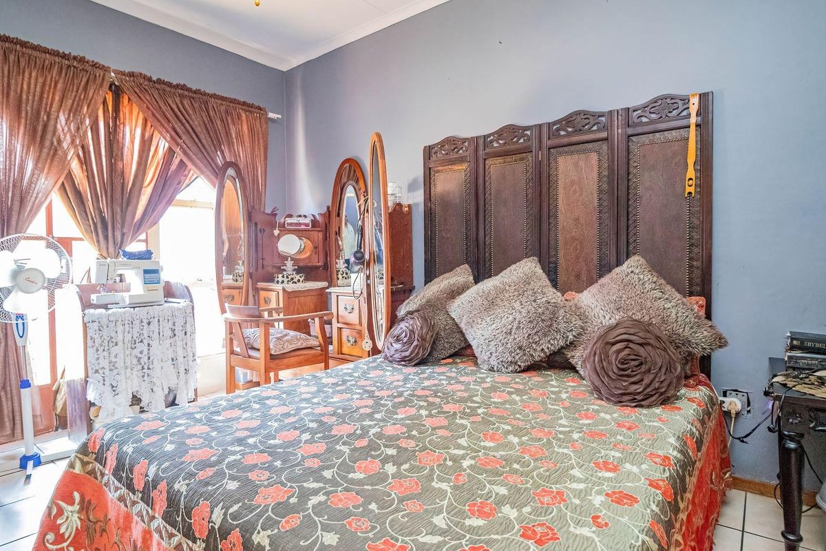 A bedroom featuring tiled flooring and a sliding glass door providing access to the exterior.