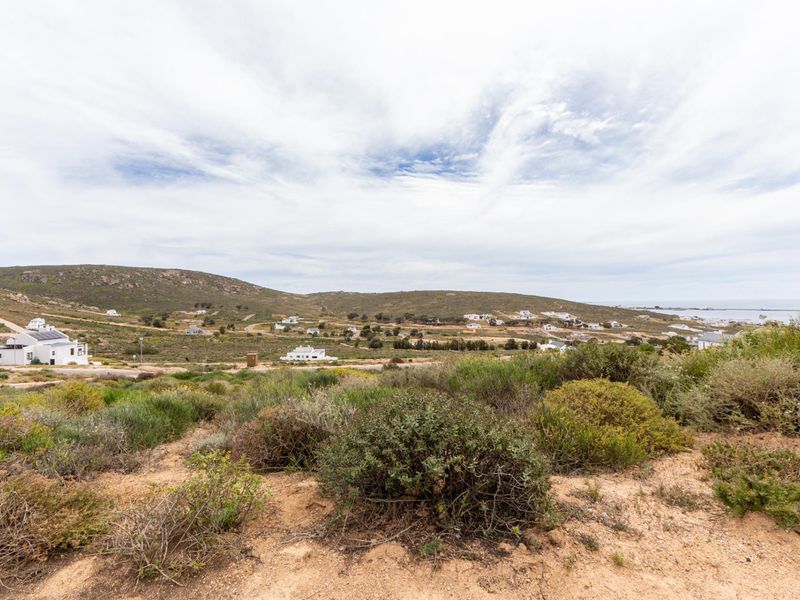 A scenic view overlooking the coastal landscape and surrounding residential area from the vacant land plot.