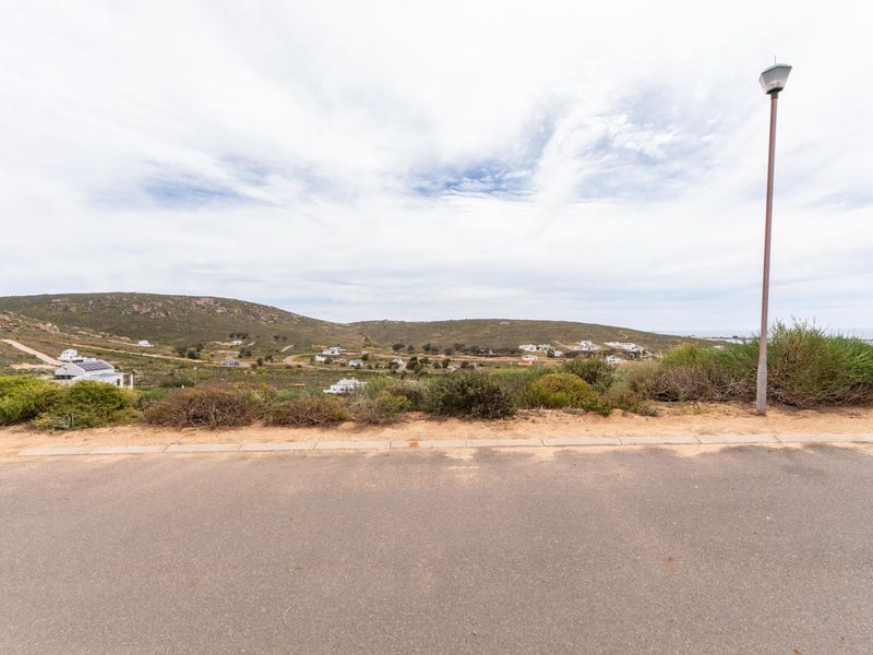 A scenic view overlooking the surrounding landscape and residential area from the street level.