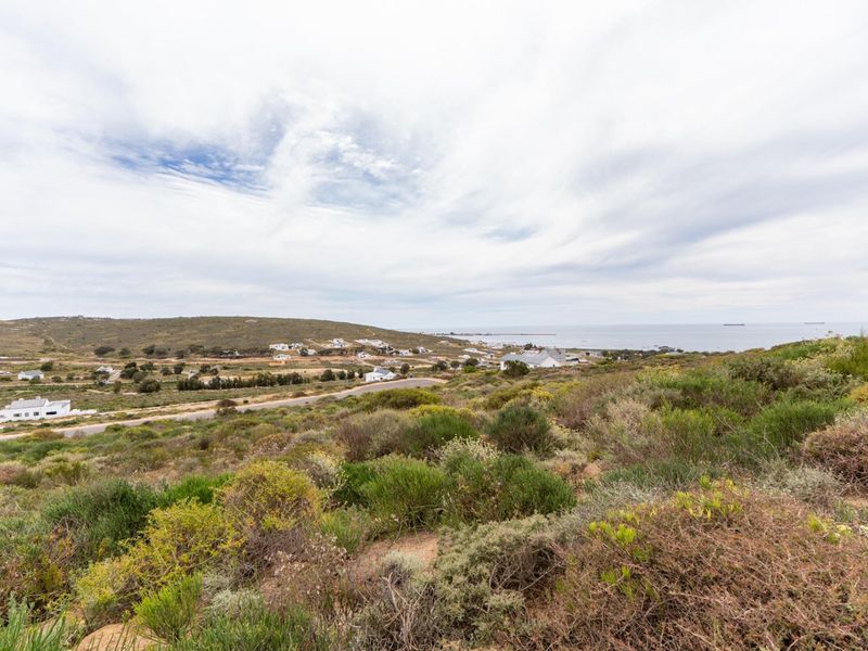 A scenic elevated view overlooking the coastal landscape, surrounding residential area, and distant ocean horizon.