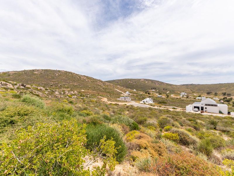 A scenic view of the natural landscape and hilly terrain surrounding the residential property.