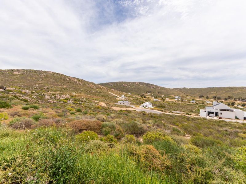 A wide-angle view of the natural hilly landscape and surrounding residential development in the estate.