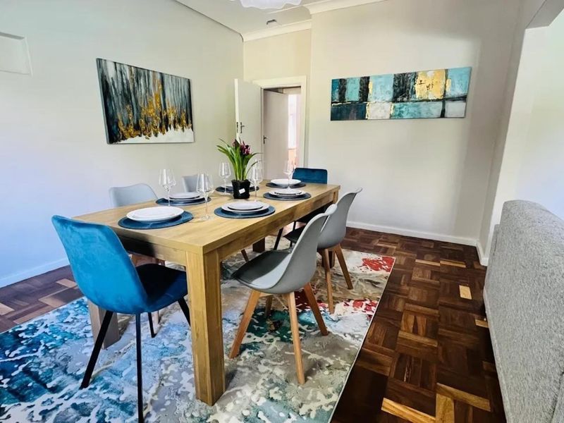 A well-maintained dining area featuring classic parquet flooring and coved cornicing, providing a warm and inviting space for meals.