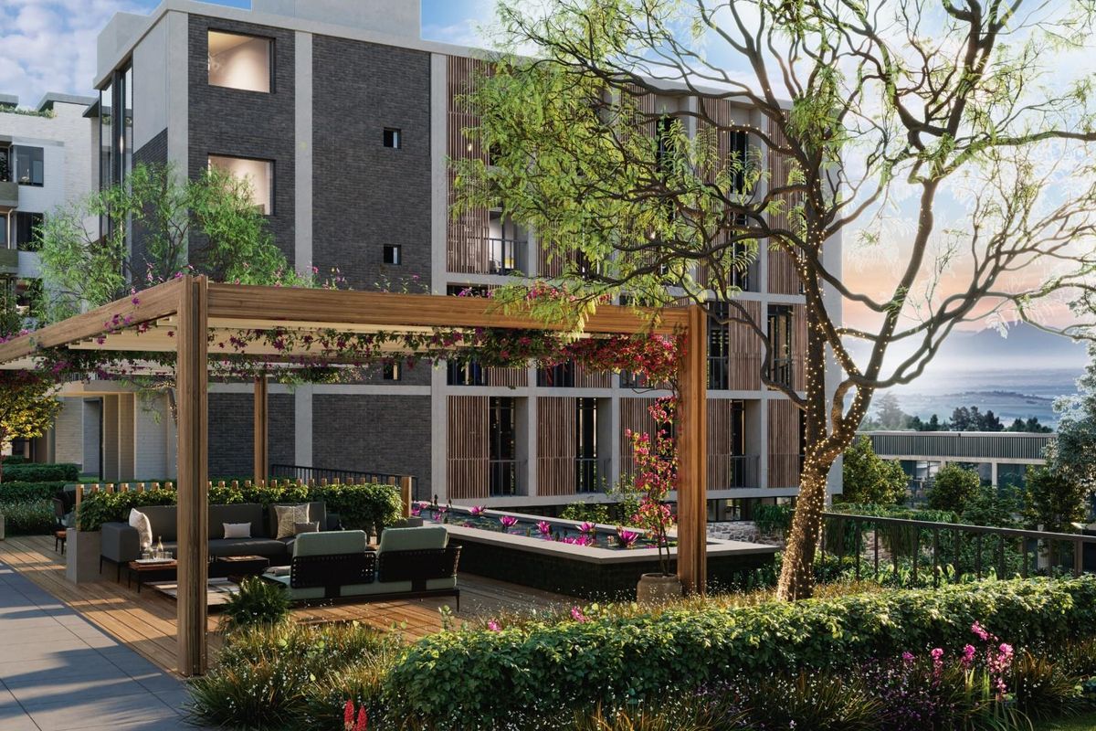 A modern apartment complex exterior featuring a landscaped terrace with a wooden pergola, water feature, and contemporary architectural design.