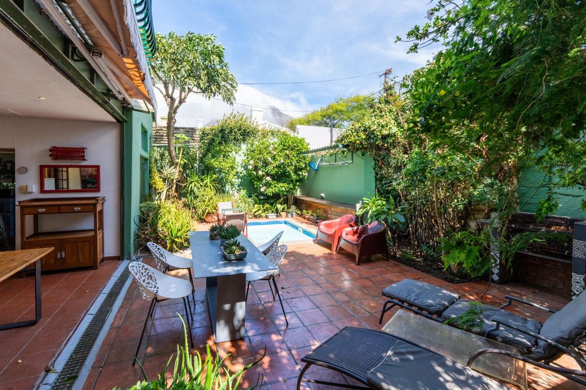 Private rear courtyard featuring a small plunge pool, terracotta tiled patio, and established garden greenery, ideal for outdoor entertaining.