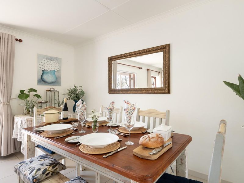 A bright dining room featuring tiled flooring and a sliding glass door providing direct access to the outdoor patio area.