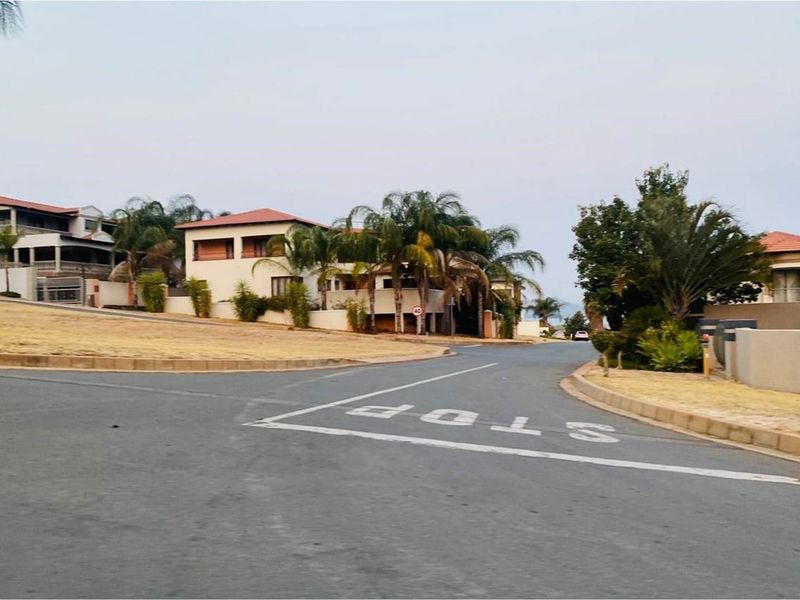 A view of the residential street and surrounding neighbourhood, showcasing the local infrastructure and established landscaping in the area.