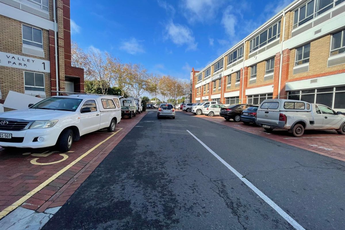 Exterior view of the Valley Park office complex featuring brick facade buildings, paved parking bays, and access road.