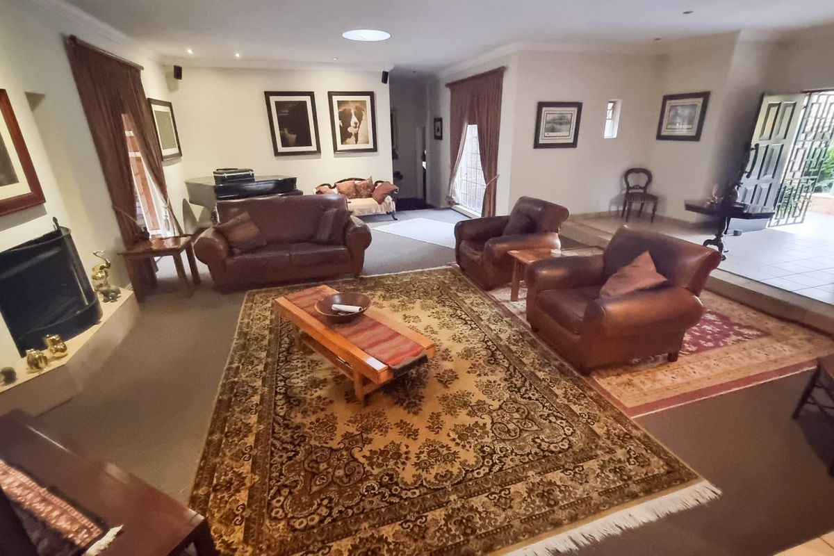 Spacious living room featuring a built-in fireplace, recessed ceiling lighting, and direct access to an outdoor patio area.