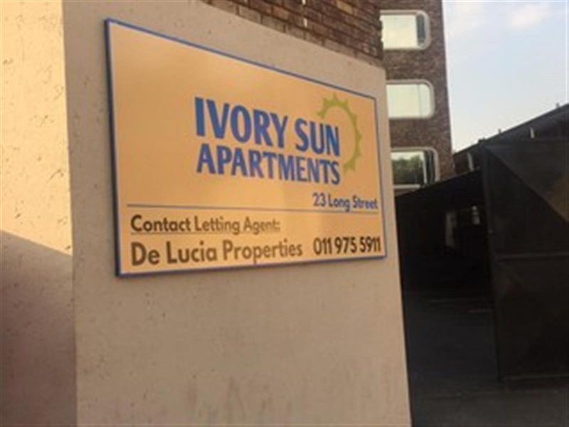 Exterior view of the Ivory Sun Apartments building signage located at 23 Long Street.