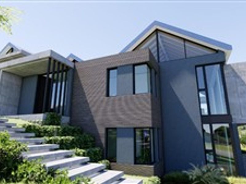 Modern architectural house exterior featuring a striking combination of brick and concrete finishes with expansive glass windows and a prominent staircase entrance.