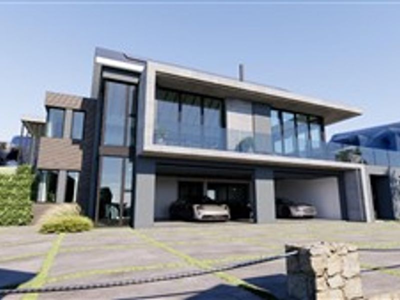Modern multi-level architectural home featuring a sleek facade, glass balcony railings, and a spacious integrated double garage with paved driveway access.