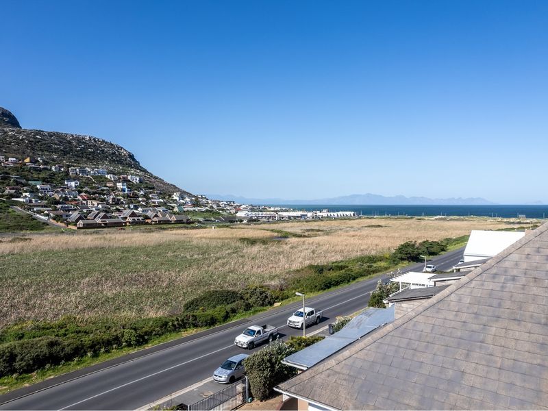 Elevated coastal view overlooking the surrounding landscape, road, and distant ocean horizon.