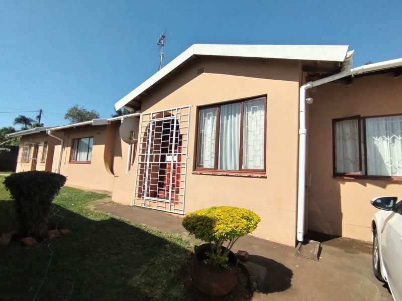 Front elevation of a single-story residential house featuring security gates, window bars, and functional guttering systems.