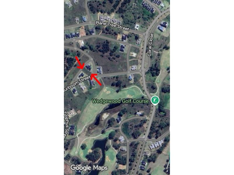 Aerial view of the residential area and surrounding golf course, highlighting the property location within the estate.