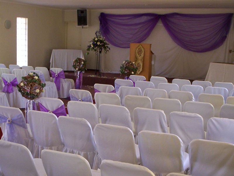 A large event or function hall featuring a raised platform area, suitable for ceremonies or gatherings.