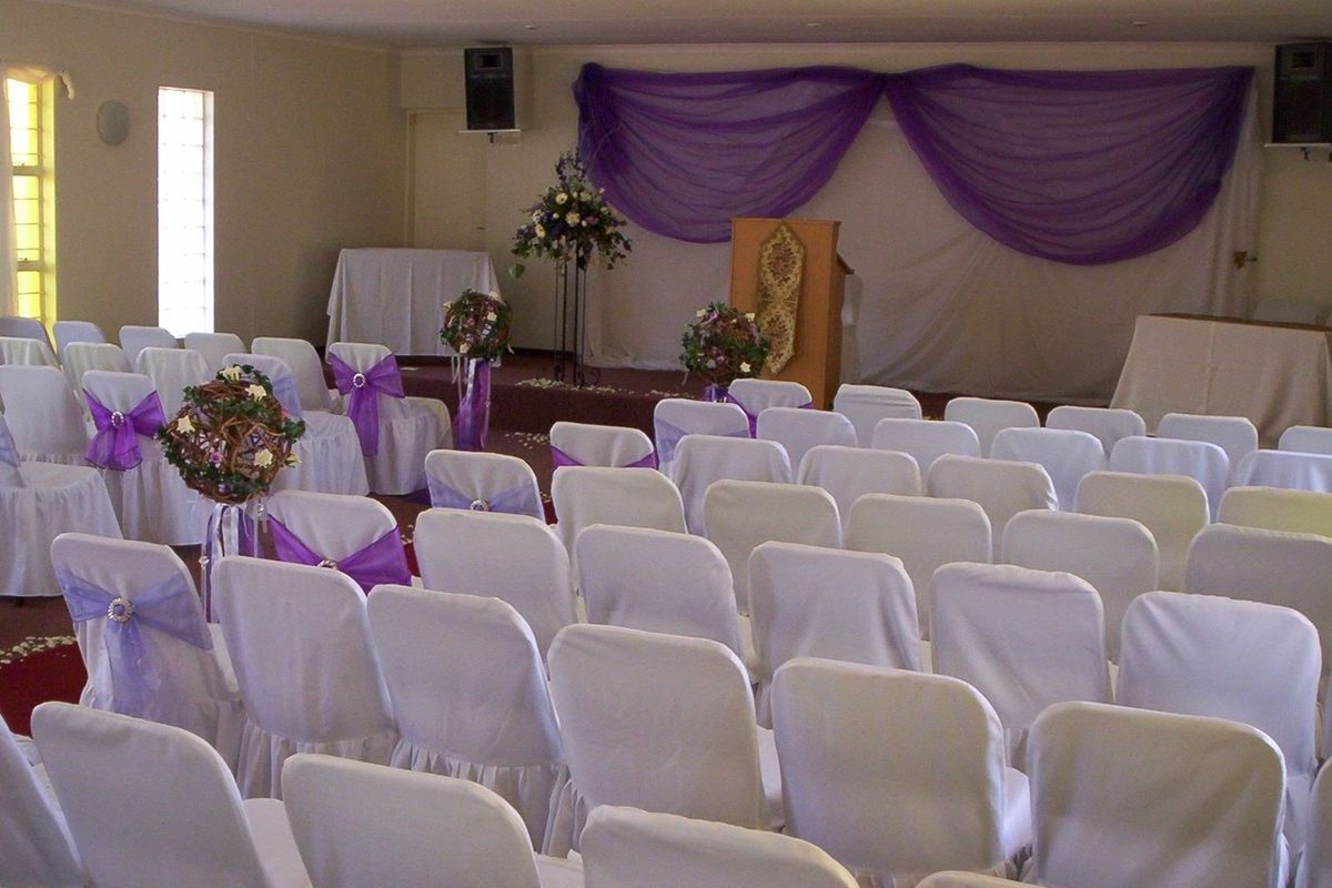 A large event or function hall featuring a raised platform area, suitable for ceremonies or gatherings.
