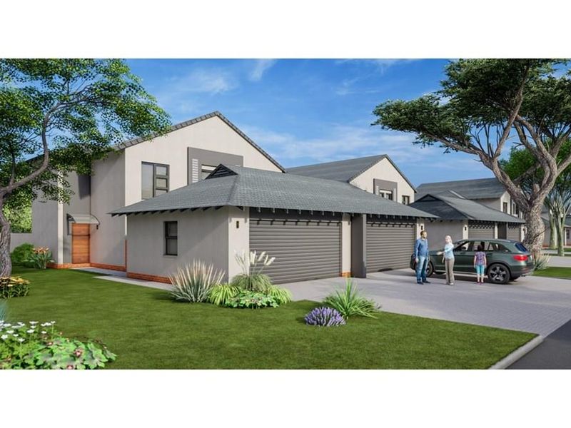 A modern townhouse exterior featuring a double garage, paved driveway, and well-maintained landscaped garden area.