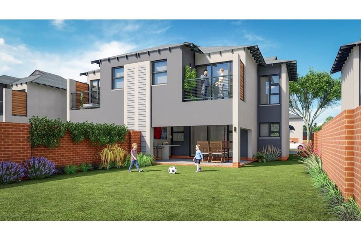 Rear view of a modern townhouse featuring a private garden, covered patio, and an upper-level balcony with contemporary architectural finishes.