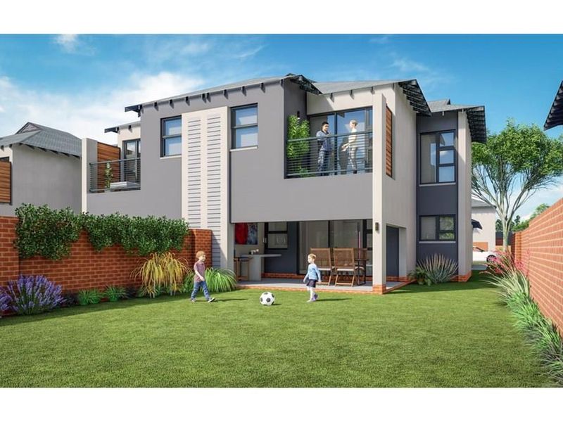 Rear view of a modern townhouse featuring a private garden, covered patio, and an upper-level balcony with contemporary architectural finishes.