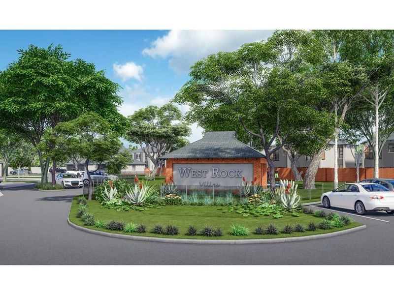 Entrance view of West Rock Village featuring a brick signage structure, landscaped garden beds, and paved driveway access.