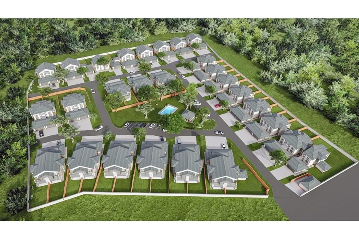 An aerial view of a residential townhouse development featuring multiple units, paved driveways, landscaped gardens, and a communal swimming pool.